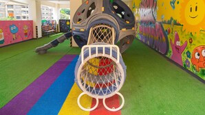 A play area with a climbing structure and colorful murals. - Amani Suite by Homes By Della (Nairobi)
