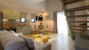 A modern apartment with a living area, kitchen, dining space, and a staircase. - Kannas Mani-Luxury Suites- Adults friendly 14+ (West Mani)