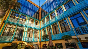 Um edifício com vários andares, varandas, janelas amplas e áreas de estar ao ar livre.