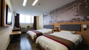 A hotel room with two beds, a desk, a chair, a TV, and a large window.
