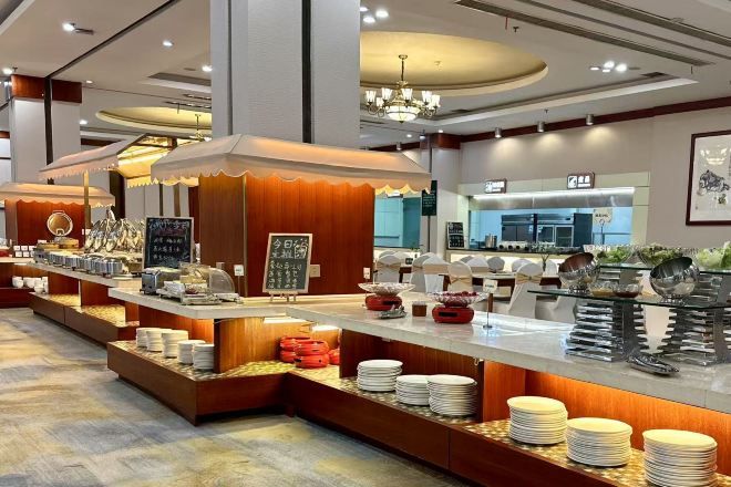 A buffet setup with multiple serving stations, a visible counter, and a seating area.