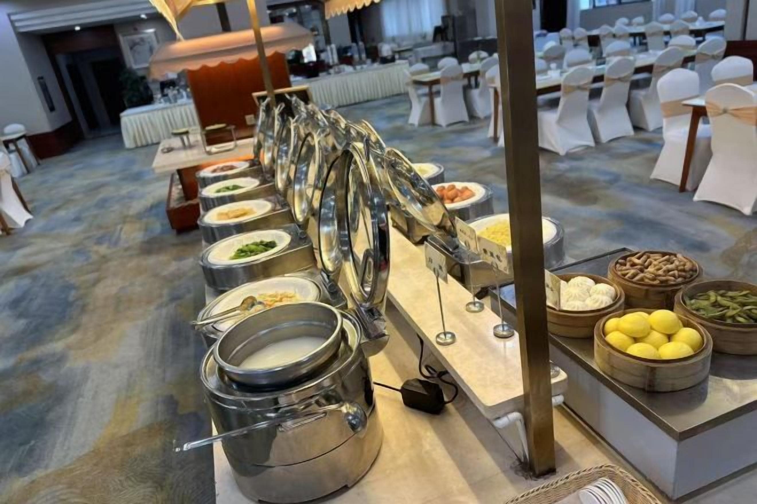 A buffet setup with multiple serving stations, including a variety of dishes and condiments.
