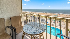 A balcony with a view of a beach and a pool. - Quay - Direct Ocean Front 3 Bedroom Condo with Indoor & Outdoor Pools! (Ocean City)
