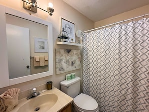A bathroom with a sink, toilet, and shower curtain. - Cozy Mountain Condo with Mountain Views (Sugar Mountain)