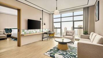 King Deluxe Suite | Living area | 55-inch flat-screen TV with cable channels, TV
