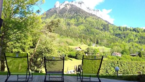 A scenic outdoor seating area with chairs facing a mountain view. - CHALET LES CLARINES between lake and mountains (Bluffy)
