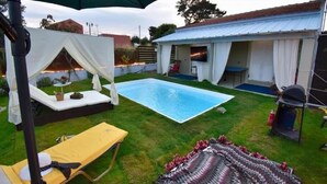 A backyard with a swimming pool, a covered seating area, and a barbecue grill. - Nirvana in Halikounas (Corfu)