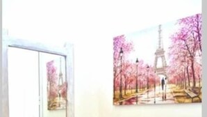 A white vanity with a mirror, two candle holders, and a small stool. A painting of the Eiffel Tower is on the wall. - Nirvana in Halikounas (Corfu)