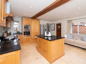 Enjoy cooking in this well-equipped kitchen with a central island and stainless steel appliances.