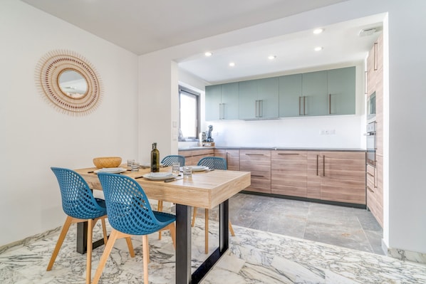 Enjoy cooking in this well-lit kitchen with a large island and sink.