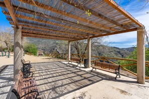 An outdoor pavilion with wooden benches and a metal railing, overlooking a mountainous landscape. - Chalet "Villa Picena Las Alpujarras" with private terrace and Wi-Fi (NEVADA)