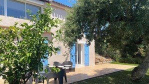 A house with a patio, outdoor seating, and a large tree. - Gazanias by Interhome (Bormes-les-Mimosas)