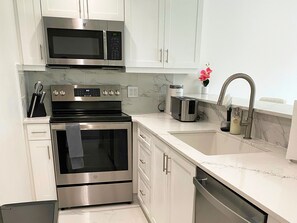 Fridge, microwave, oven, stovetop - Luxury Large Leeward Condo - walk to the beach (Leeward Settlement)