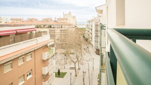 A residential building with multiple balconies, a clear sky, and a view of the sea. - Aiguadolç - Alojamientos MarCalma (Tarragona)