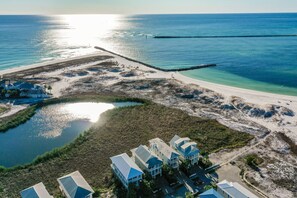 An aerial view of a coastal property with multiple buildings, a beach, and a water body. - 2BR Gulf-View Condo with Balcony + Bikes & Pools | Magnolia House 204 (Destin)
