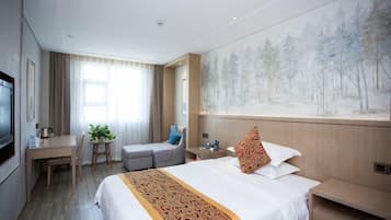 A hotel room with a bed, a desk, a chair, a TV, and a painting on the wall.