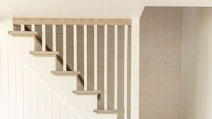 A staircase with wooden steps and white railings.
