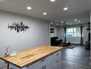 A modern kitchen with a wooden countertop and built-in drawers. - Wyoming 2 (Anchorage)