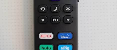 A remote control with directional buttons, an OK button, and buttons for Netflix, Hulu, and Sling.