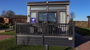 A modern building with a sign indicating it is a Willerby accommodation. - Owls Nest (York)