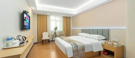 A modern hotel room with a bed, bedside table, TV, and a desk with a chair.
