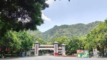 A road leading to a gate with a mountain backdrop.