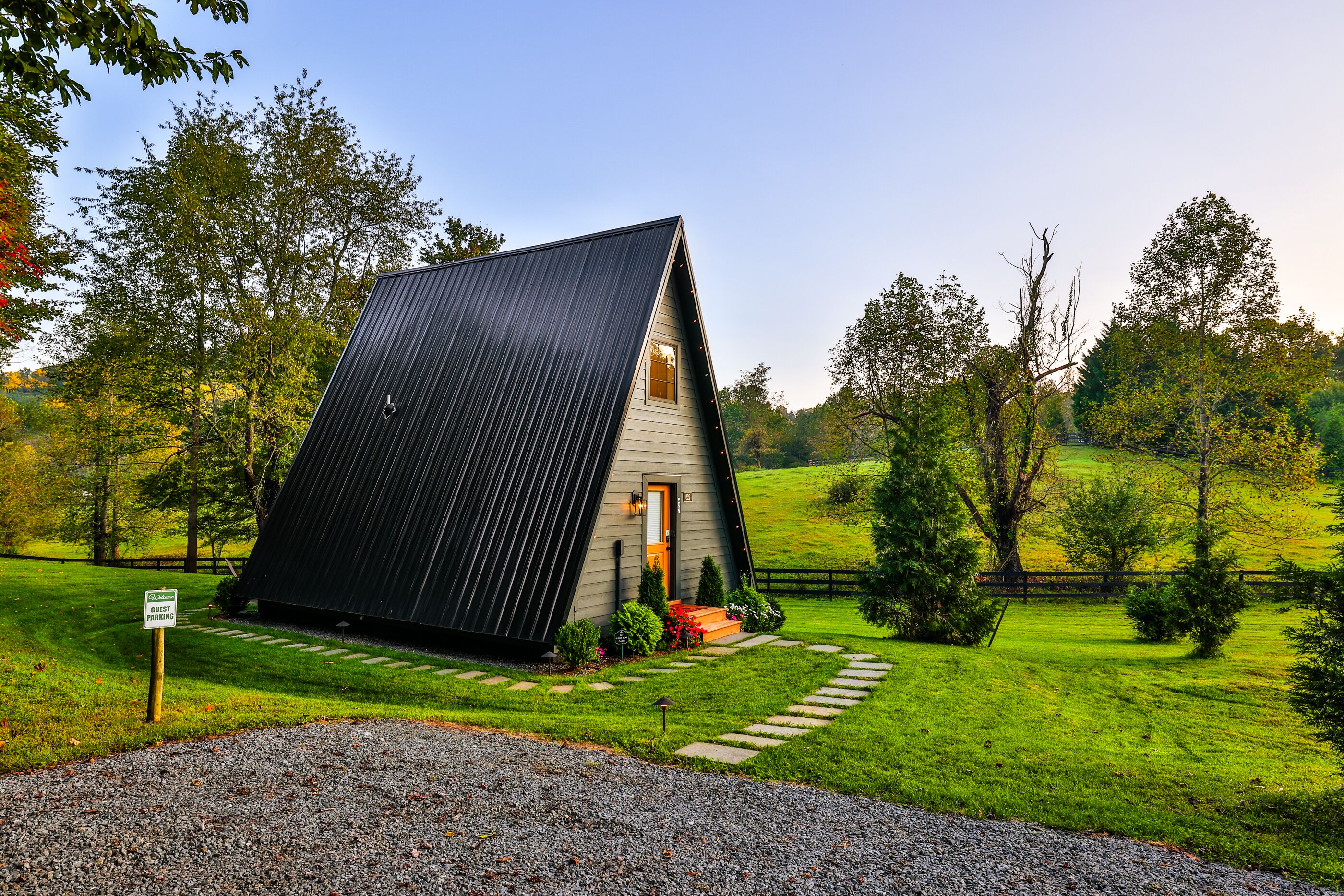 A house with a sloped roof, a front door, and a small porch with steps.