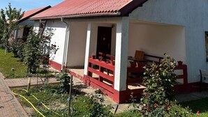 A single-story building with a red-tiled roof and a white exterior. - Delta crisan flamingo (Crisan)