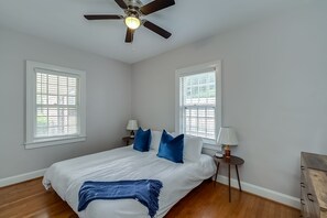 A bedroom with a bed, two nightstands, a ceiling fan, and two windows with blinds. - Chevy Chase-1mi to Rupp-Kroger Field-Downtown (Lexington)
