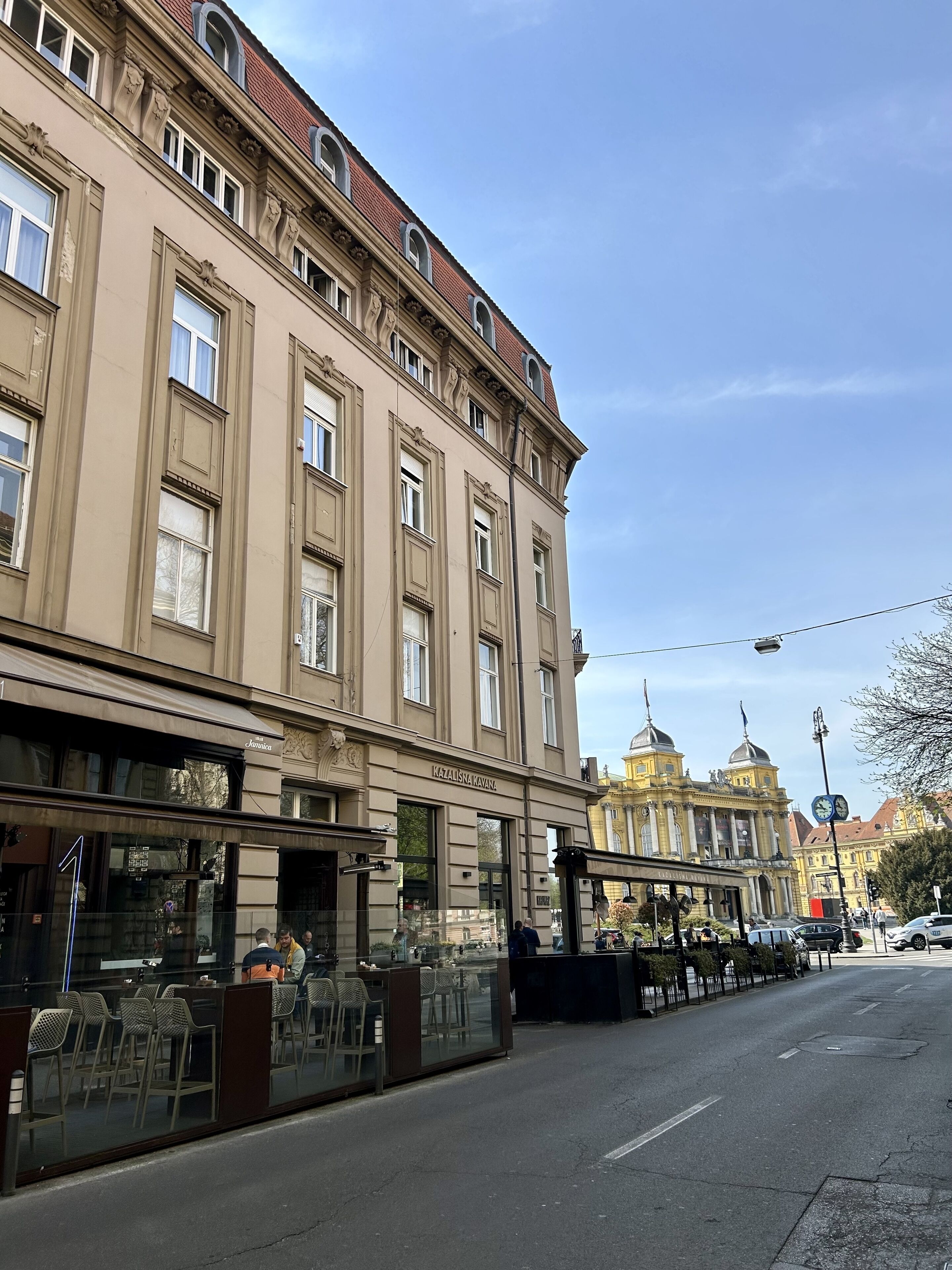 A building with large windows and a sign reading "KAZAUSINA KAVANA".