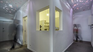 A corridor with white walls, a door, and a window. - Chiado Prime Suites I by Homing (Lisbon)