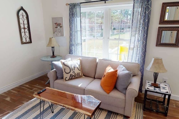 Relax on the super-comfy memory-foam sofa (folds out into a full-size bed) and enjoy the cozy electric fireplace and easy access to the front porch.