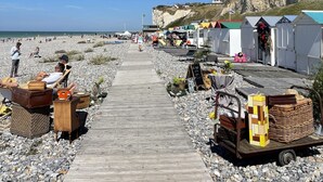 A wooden pathway leading to beachside cottages with a rocky beach and cliffs in the background. - COTE D'ALBÂTRE BEACH 5 MINUTES AWAY (Criel-sur-Mer)