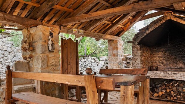 An outdoor wooden structure with a stone wall and a fireplace. - Sage House - One Bedroom Holiday Cottage with Terrace (Trpanj)