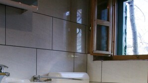A bathroom with a toilet, sink, and cabinet. - Sage House - One Bedroom Holiday Cottage with Terrace (Trpanj)