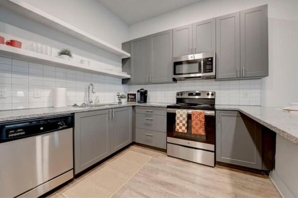 Enjoy cooking in this well-equipped kitchen with a dishwasher, oven, and microwave.