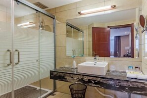 A modern bathroom with a glass shower enclosure, a marble vanity, and a large mirror. - Wancheng Hotel (Qianshan)