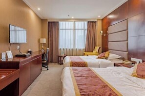 A hotel room with a desk, two beds, a TV, and a window with curtains. - Wancheng Hotel (Qianshan)