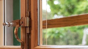 A wooden window frame with a metal latch. - Sage House (Trpanj)