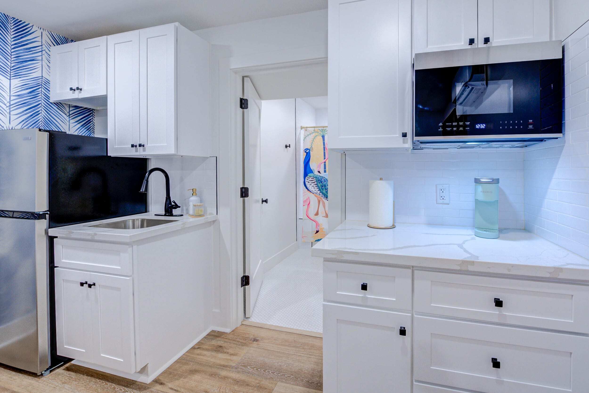 Fridge, microwave, coffee/tea maker, cookware/dishes/utensils