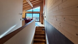 A wooden interior with a staircase leading to an outdoor area. - Chalet Dinkel in Niedernsill 8-B (Niedernsill)