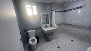 A bathroom with a toilet, sink, and shower. - La Perla Motel (South Gate)