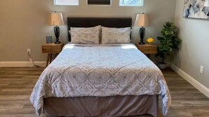 A bedroom with a large bed, two bedside tables, and three windows. - High End Guest House by I-5, Bethel, Simpson (Redding)