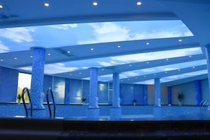 A spacious indoor area with a high ceiling, large pillars, and a reflective floor. - Jintian International Hotel (Suqian)