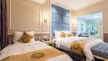 A hotel room with two beds, a large mirror, and a view of the bathroom.