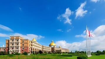 A large building with multiple domes and a flagpole.