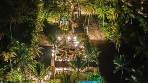 An aerial view of a resort with multiple swimming pools, lounge areas, and a large central pool. - Zai Patacho (Porto de Pedras)