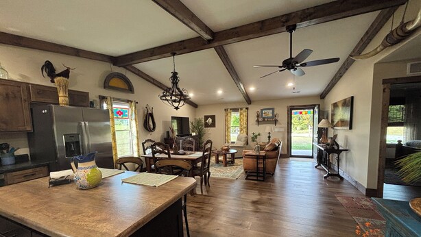 A spacious kitchen with a large island, wooden beams, and a ceiling fan. - Secluded 2 Bedroom Sanctuary on 20 Acres in the Heart of the Bourbon Trail (Chaplin)