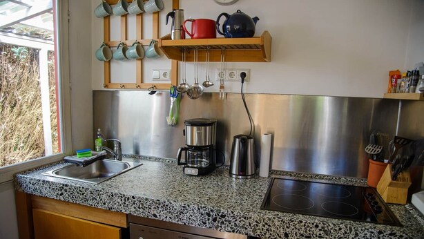 Una cocina con encimera de granito, electrodomésticos de acero inoxidable y lavavajillas.