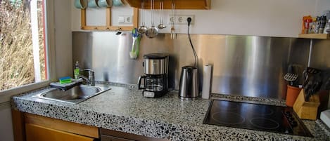 A kitchen with a granite countertop, stainless steel appliances, and a dishwasher.